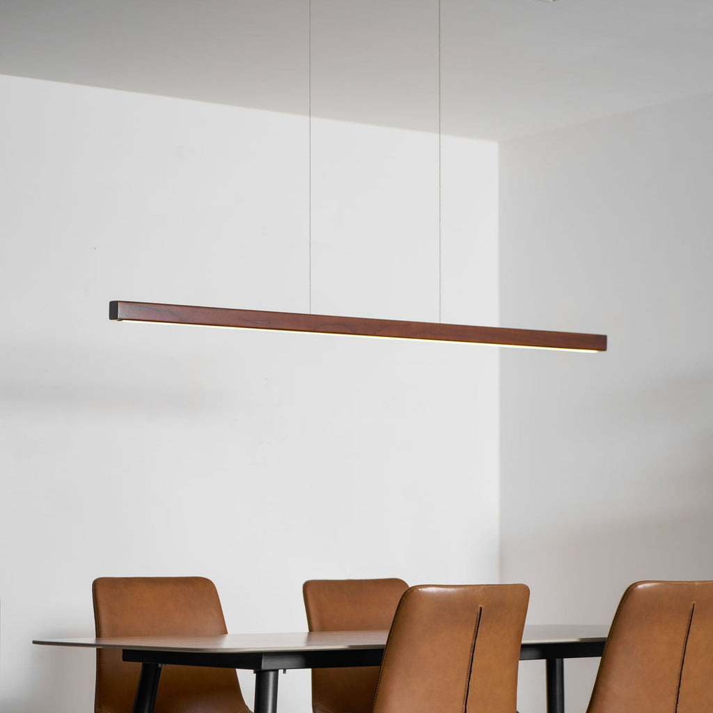 Wooden linear pendant light shown on a neutral backdrop