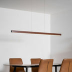 Wooden linear pendant light shown on a neutral backdrop