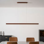 Wooden pendant light slim linear form on a clean background