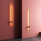 Linear LED wall light mounted vertically with soft glow