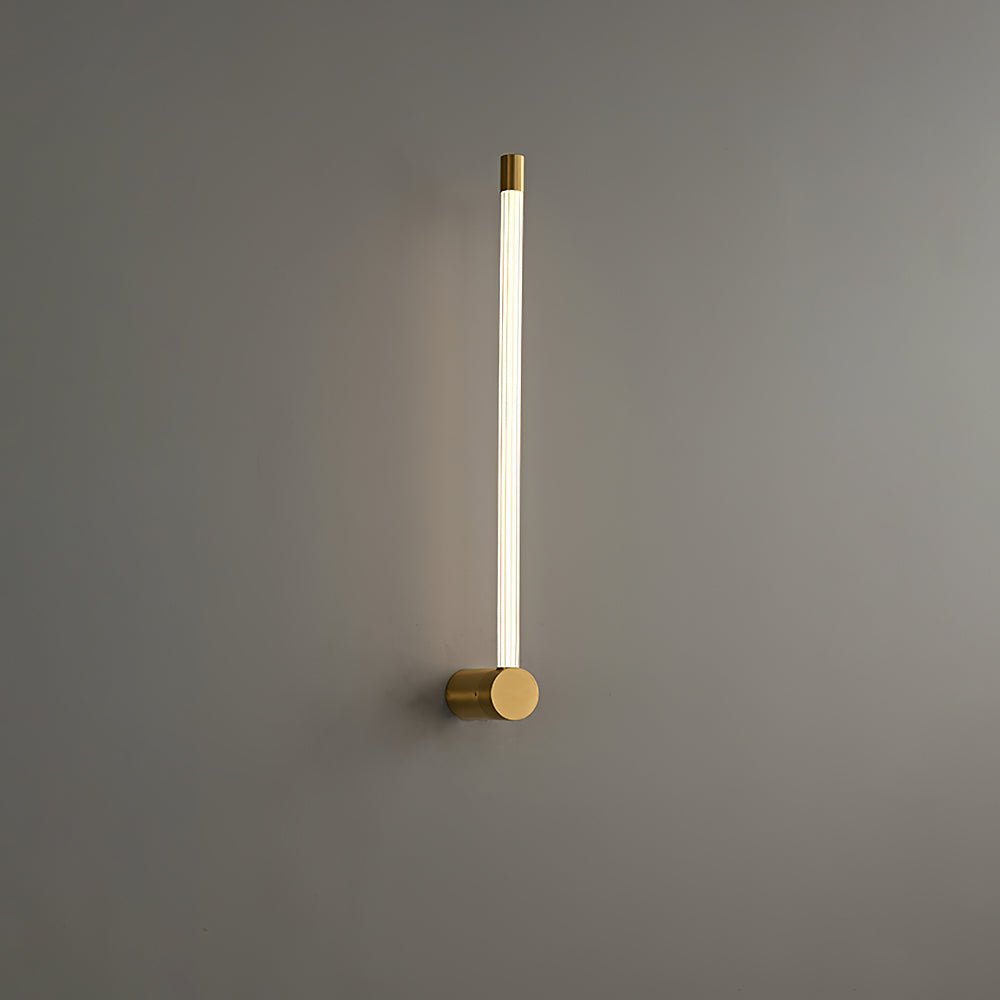 Slim linear LED wall sconce glowing in a soft vertical line