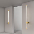 Linear LED wall sconce glowing warm above a side table