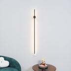 Black slim tube wall light shown against a neutral background