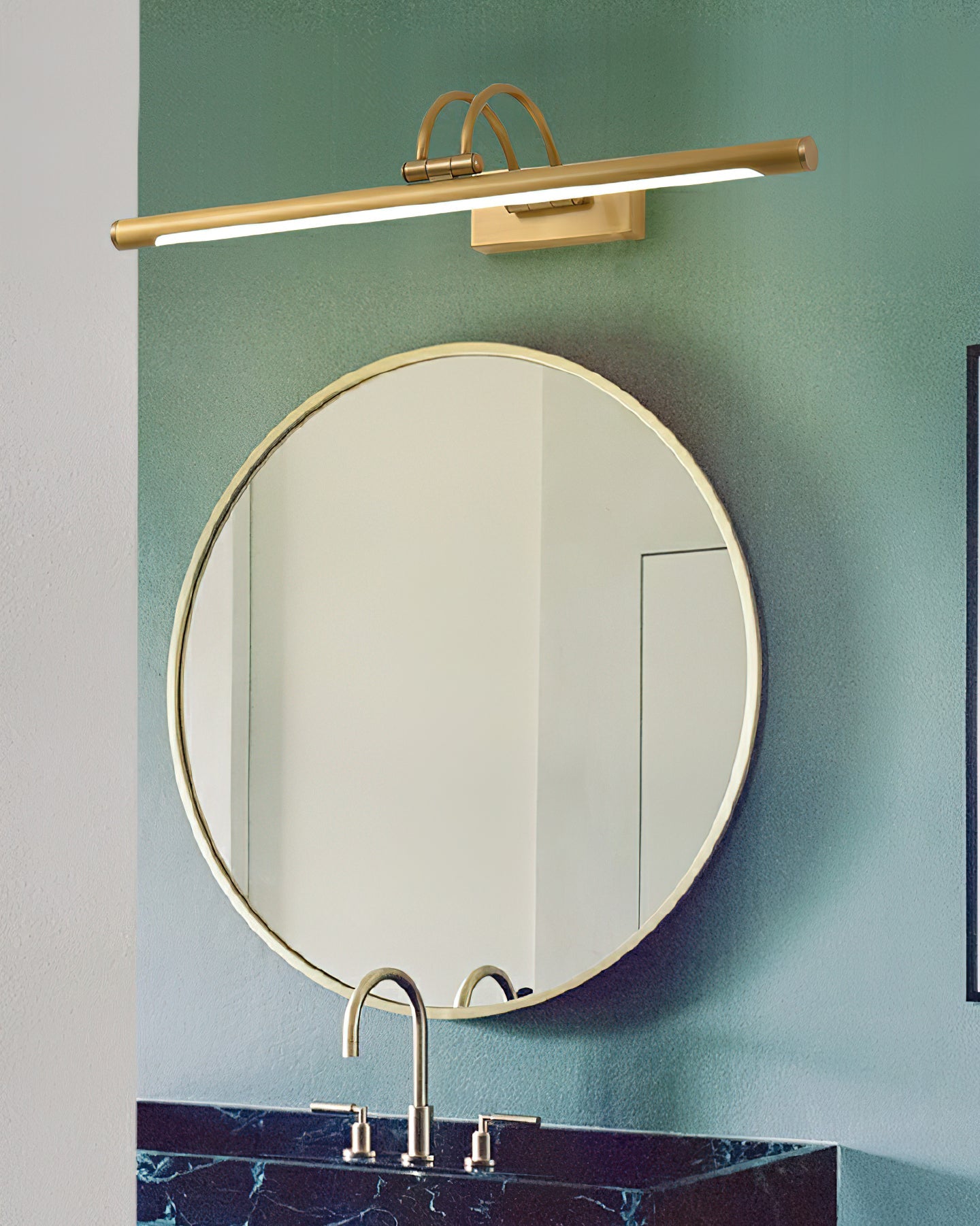 Linear vanity light in dark bronze glowing above a vanity mirror