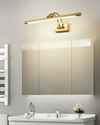 Dark bronze vanity light with brushed brass ends glowing softly