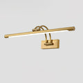 Linear vanity wall light in dark bronze glowing above a mirror