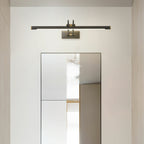 Dark bronze and brass vanity light casting soft even illumination