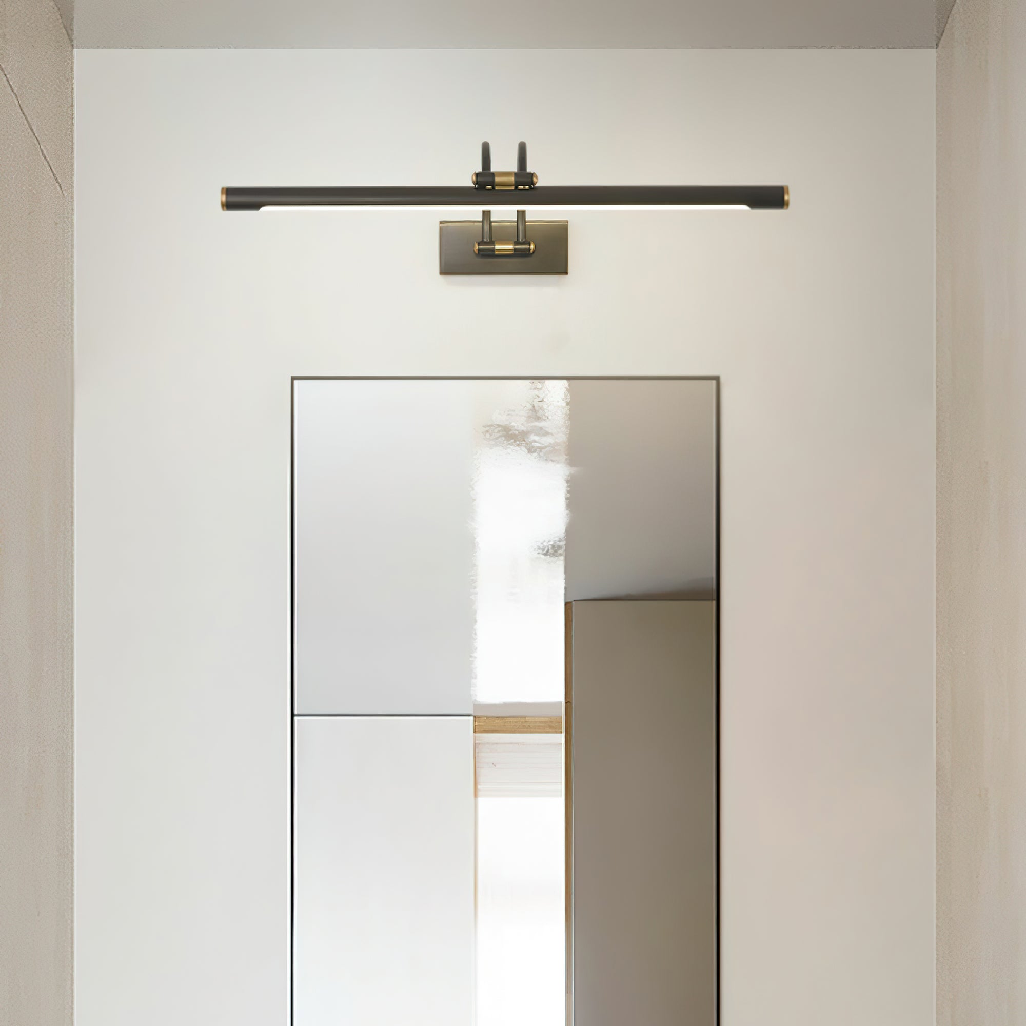 Dark bronze and brass vanity light casting soft even illumination