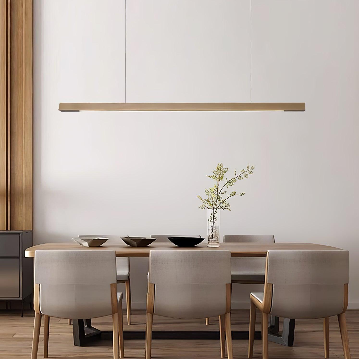 Linear wooden pendant light hung low over a kitchen island