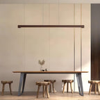 Wooden linear pendant light shown with warm light below