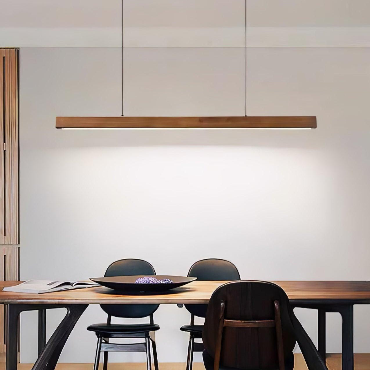 Linear wooden pendant light fixture viewed from an angle