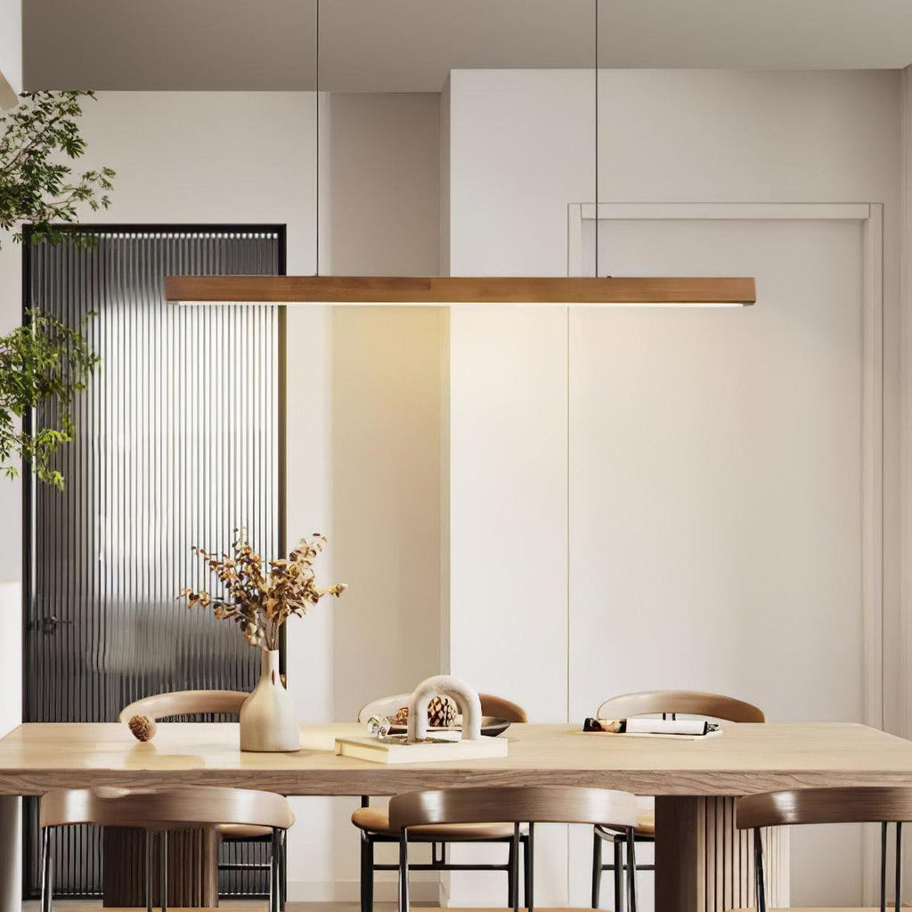 Linear wooden pendant light over a table in a cozy setting