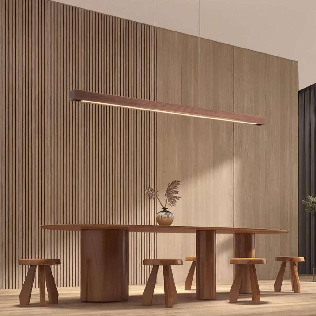 Wooden pendant light slim linear fixture against a plain wall