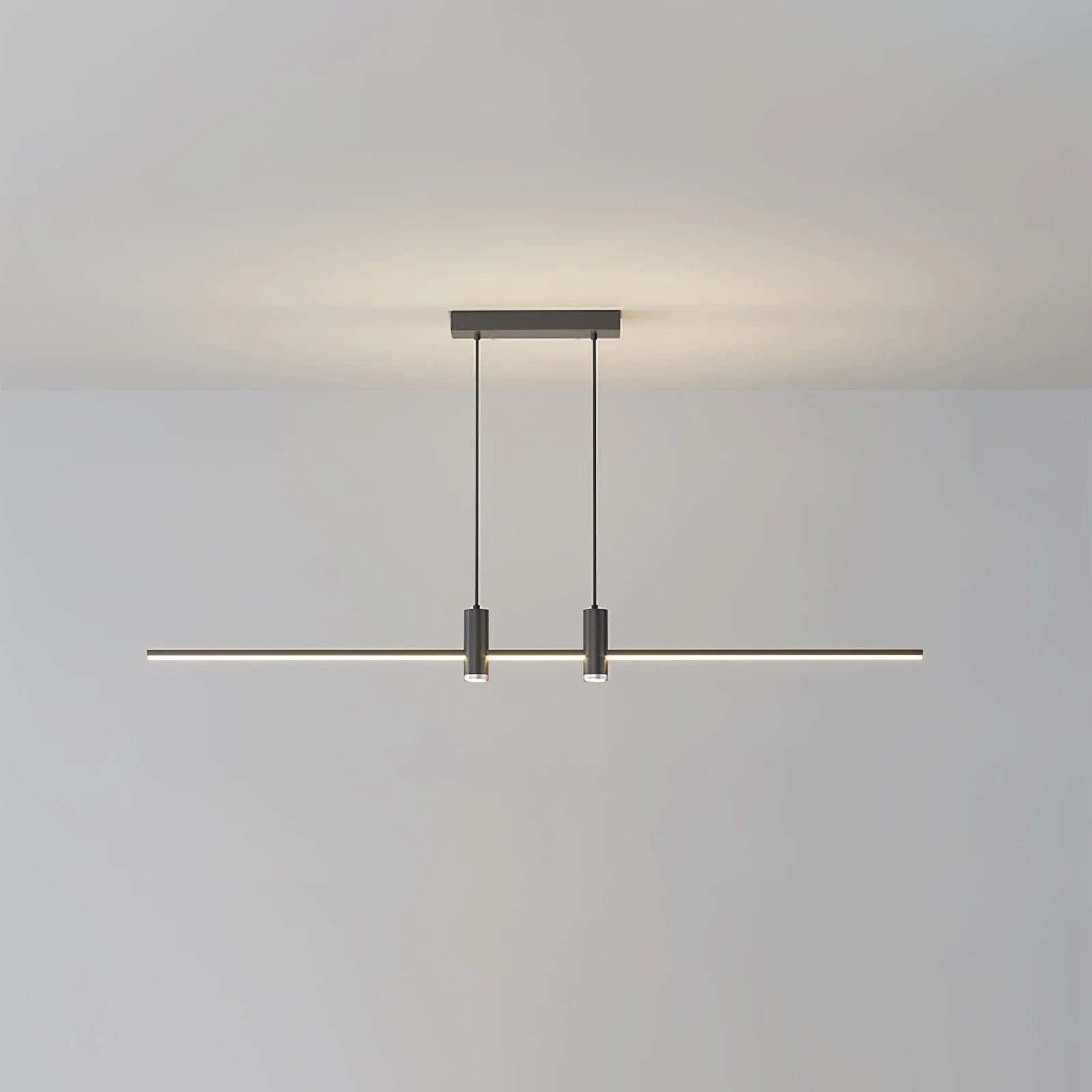 Linear bar pendant light hung low over a kitchen island