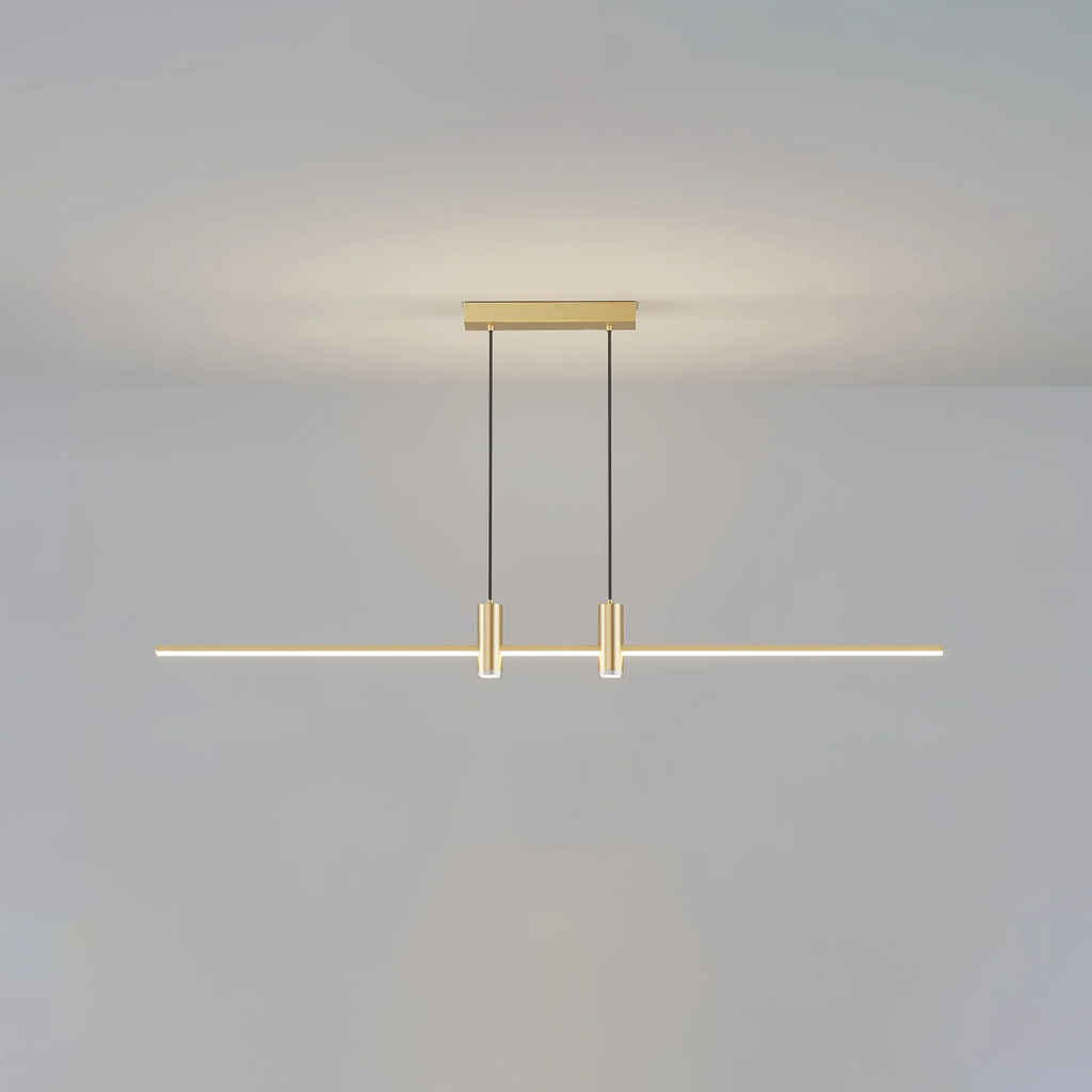 Linear bar pendant light glowing edge to edge over a counter