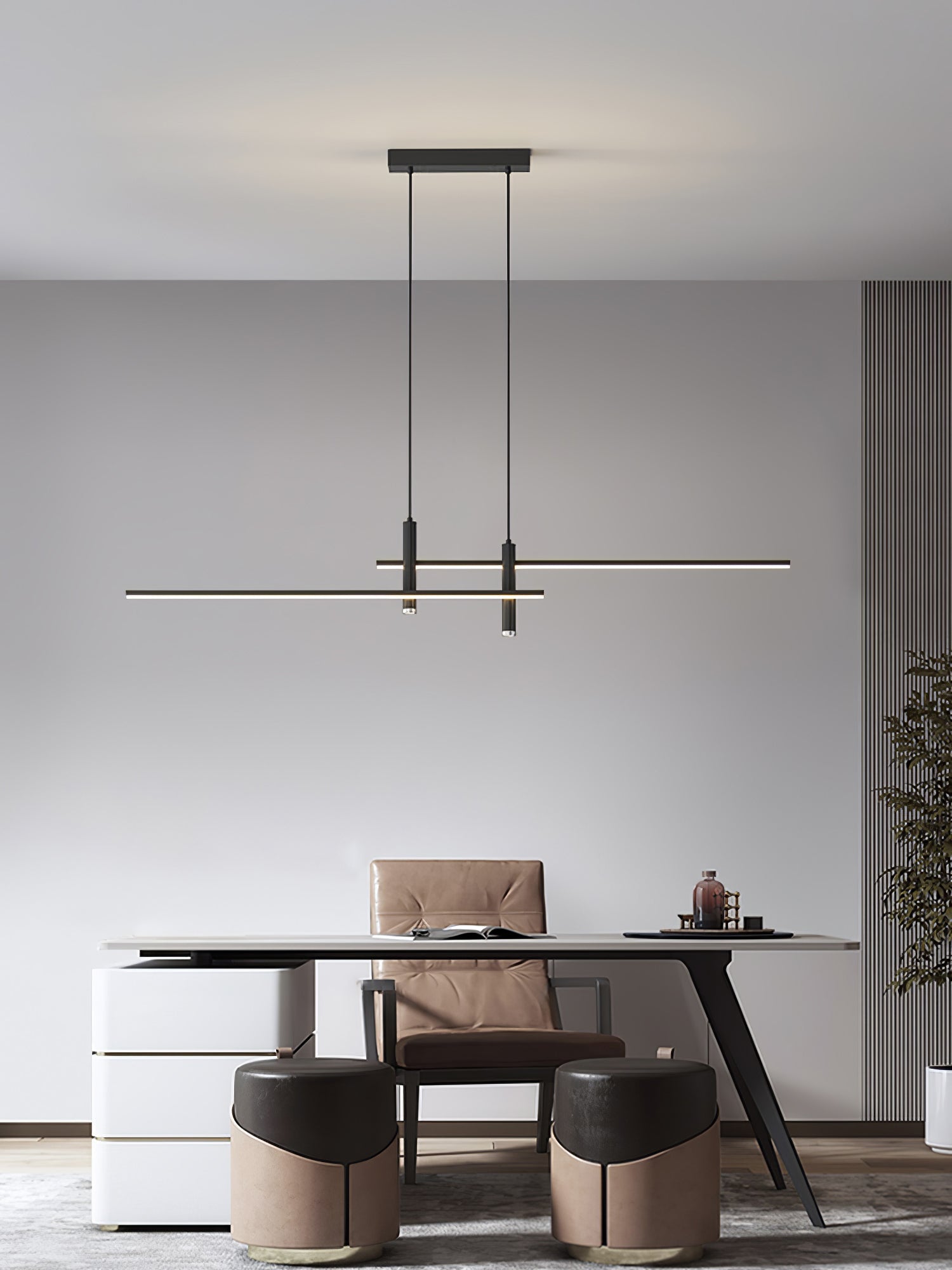 Linear pendant light glowing over an island in a styled kitchen