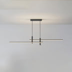 Linear pendant light with white shade glowing over a dining island