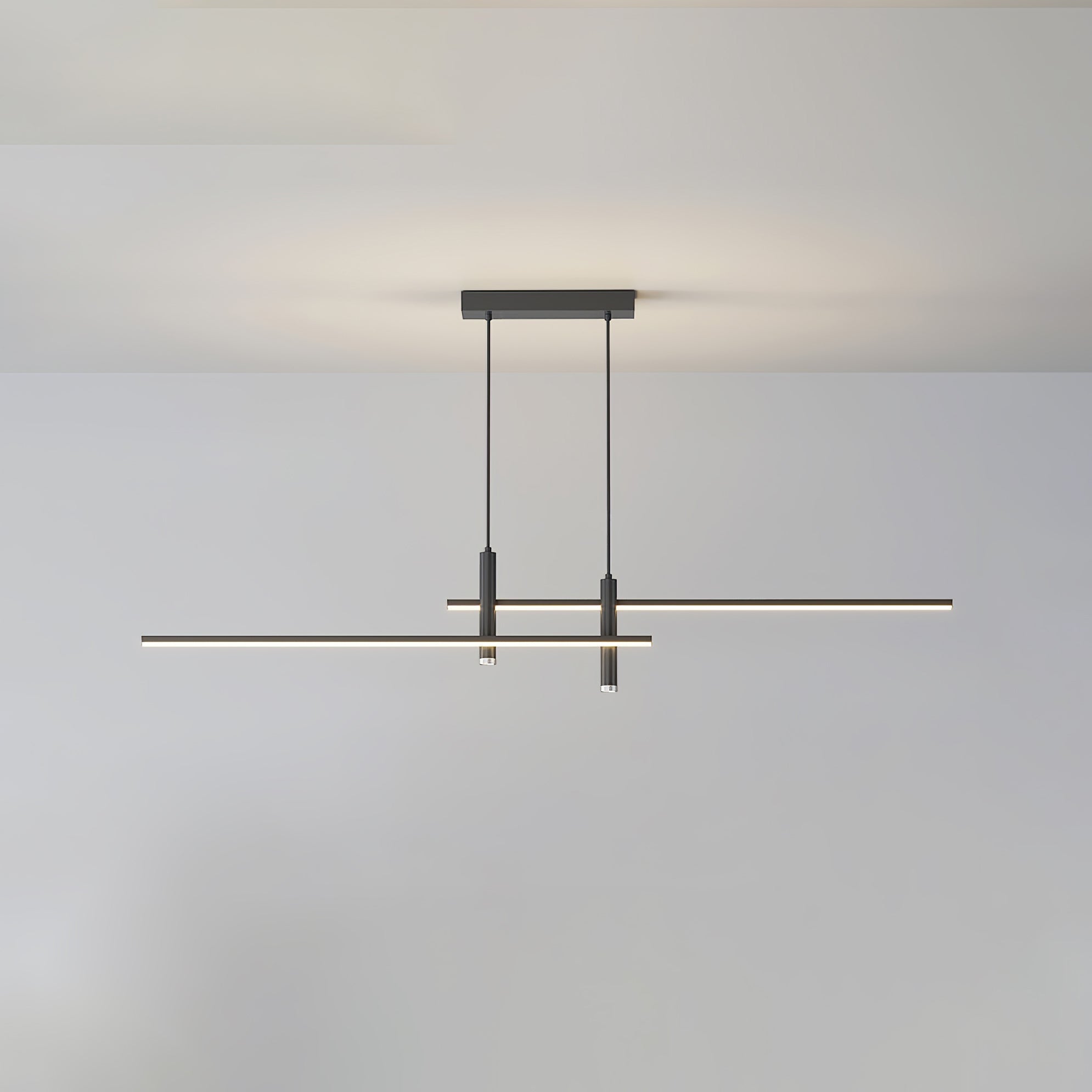 Linear pendant light with white shade glowing over a dining island