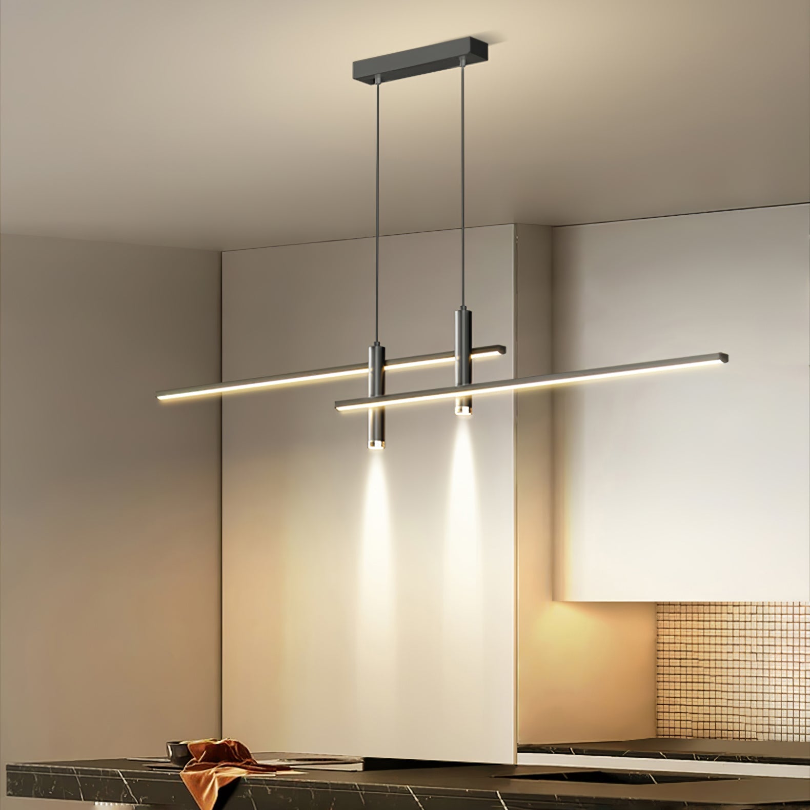 Linear island pendant light illuminating a modern dining space