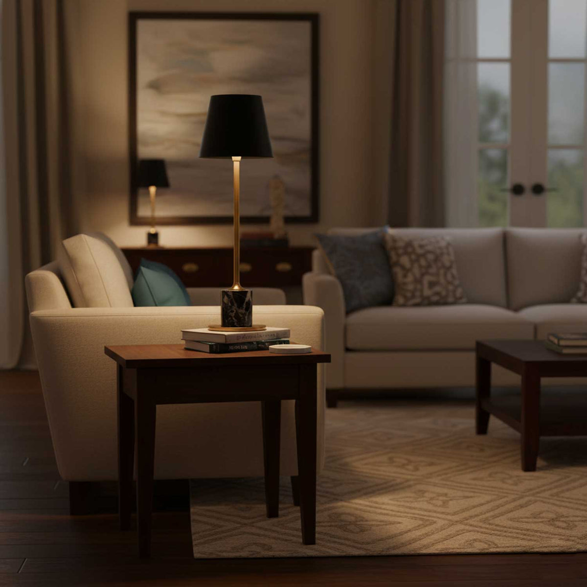 A Clérachic marble table lamp sits on a wooden side table beside a cream sofa, a framed abstract print hung above it.