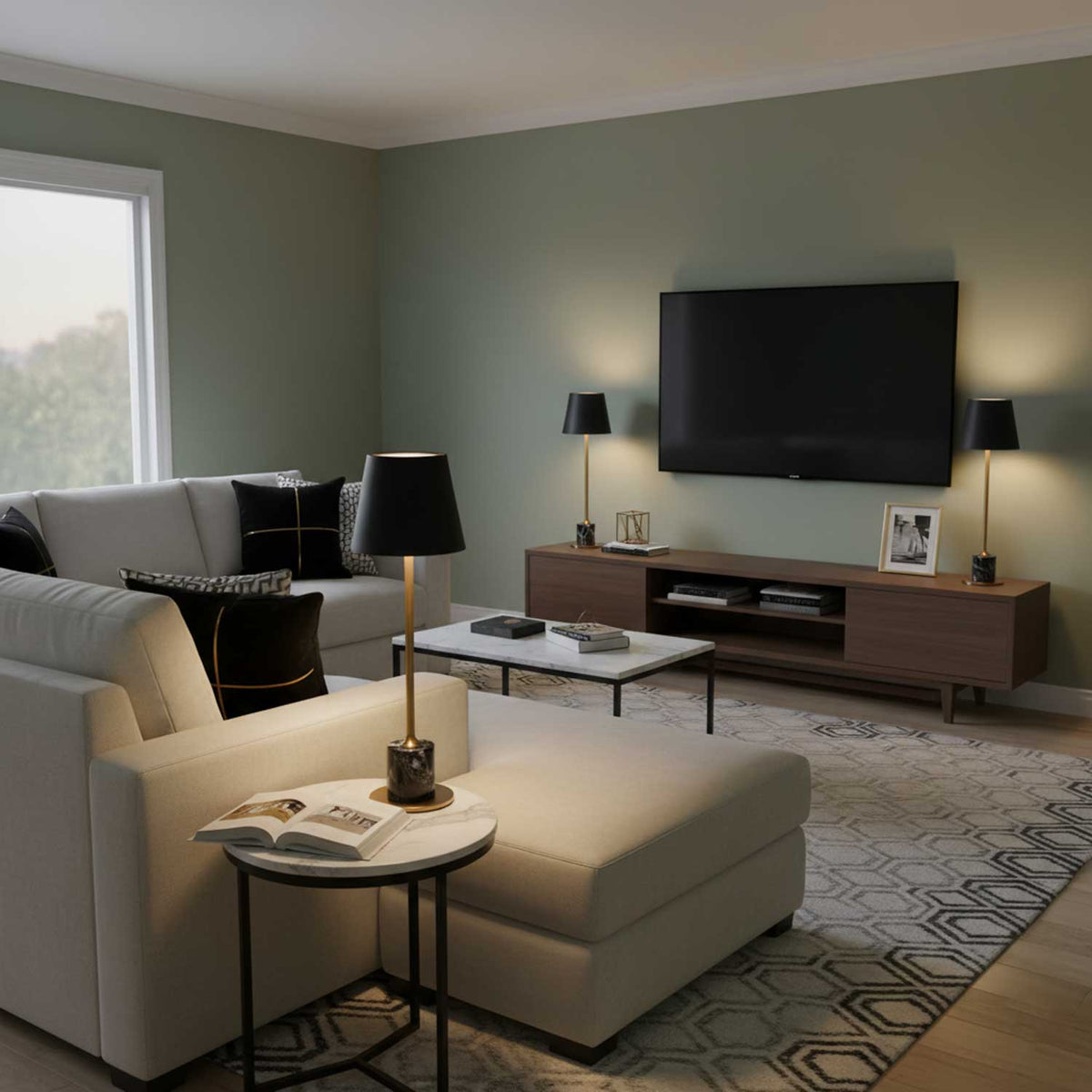 A Clérachic marble table lamp lights a round side table between a beige sofa and ottoman, a television visible across the room.