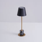 A Clérachic marble table lamp on a plain white studio background, the shade's open top rim visible from this angle.