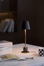 The same styled marble-tabletop scene as the previous frame, the Clérachic lamp shot from a slightly different angle.