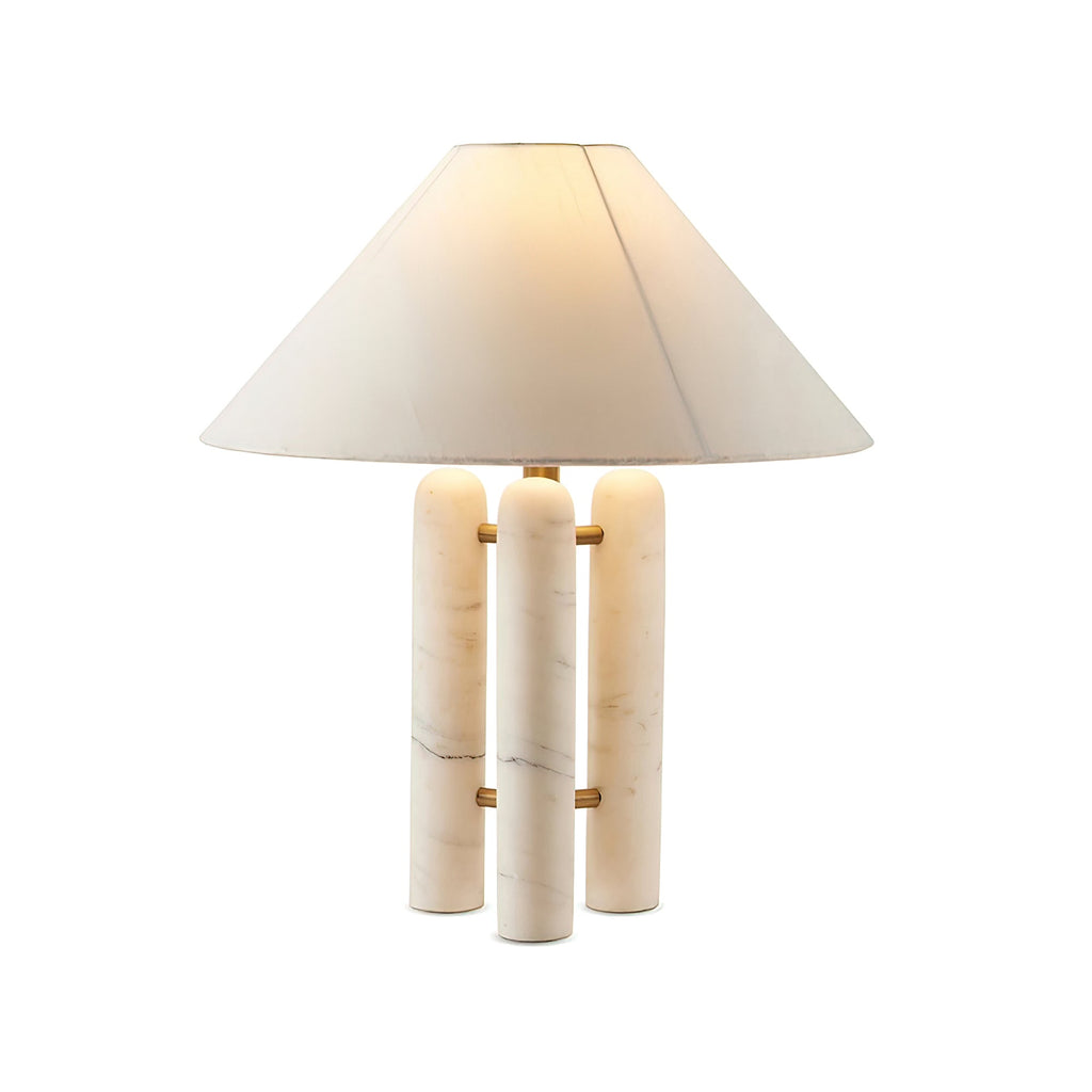 Clérachic table lamp on a plain white background, its wide conical shade catching warm lamplight from within.