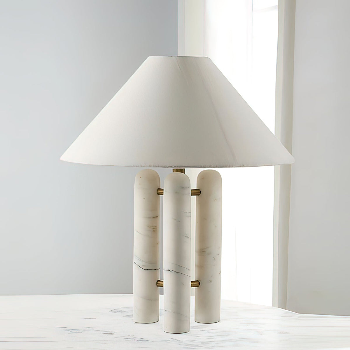 Same Clérachic lamp on the marble table, a wider view taking in more of the tabletop and window behind it.