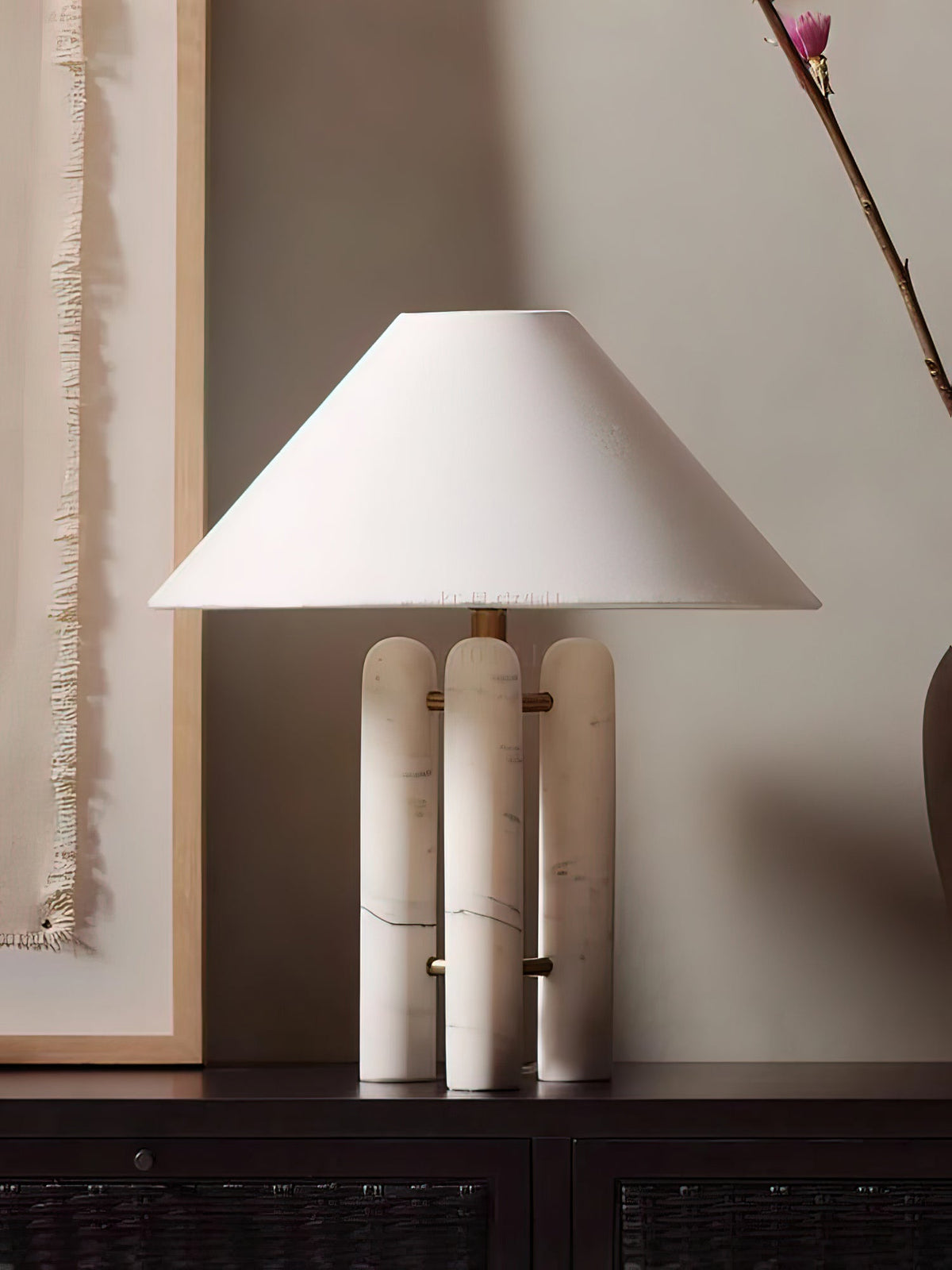 Clérachic table lamp on the same dark console, cropped closer with the curtain's fringed edge in view.