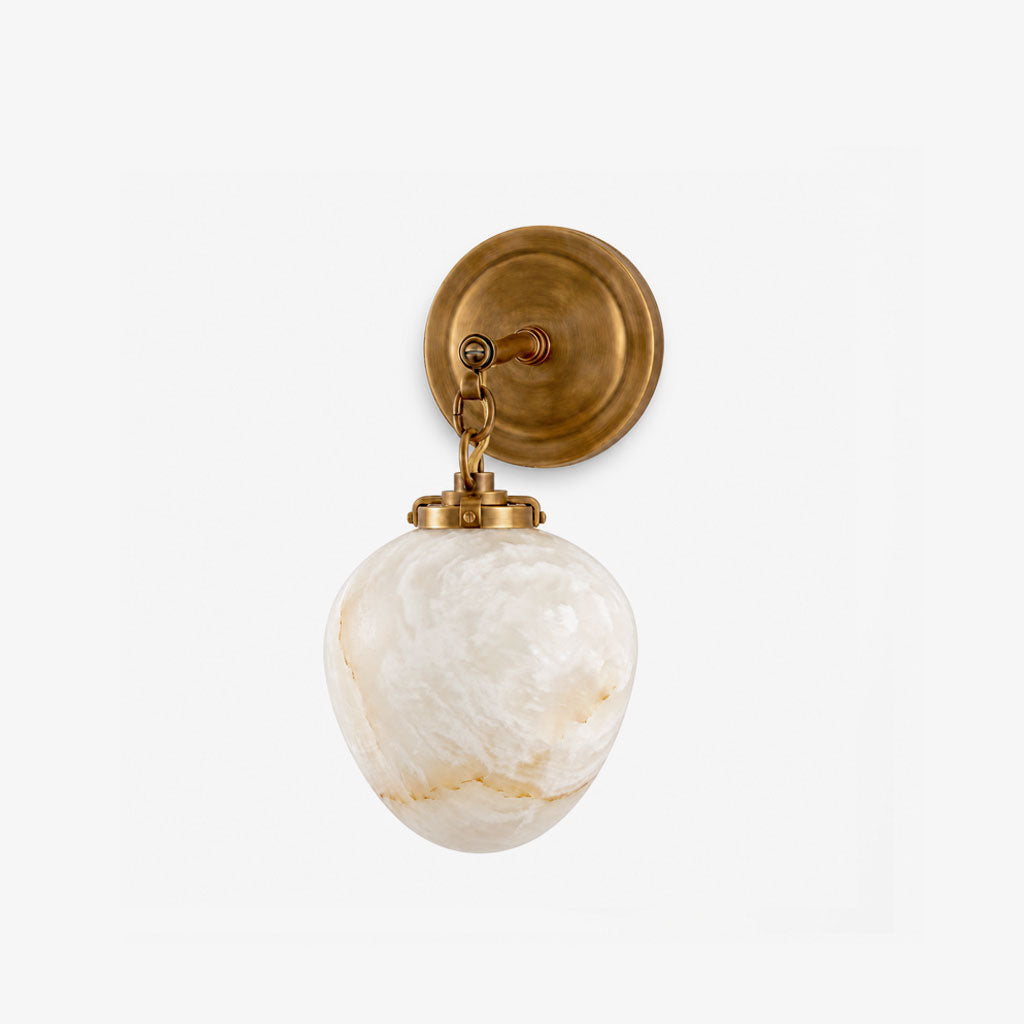 A side angle of this Clérachic wall sconce in brass finish, showing the chain that suspends its alabaster shade.