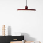 Round disc pendant light front view with even warm glow
