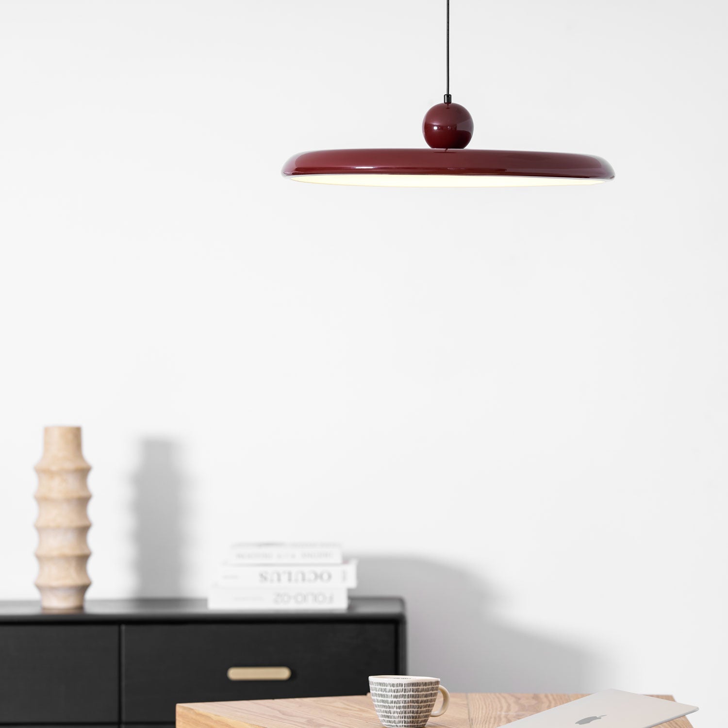 Round disc pendant light front view with even warm glow