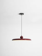 Round disc pendant light close view of the lit white disc