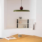 Disc pendant light glowing above a relaxed seating area