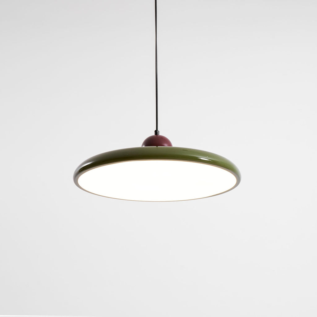 Disc pendant light styled above a console in a living space