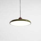 Disc pendant light styled above a console in a living space