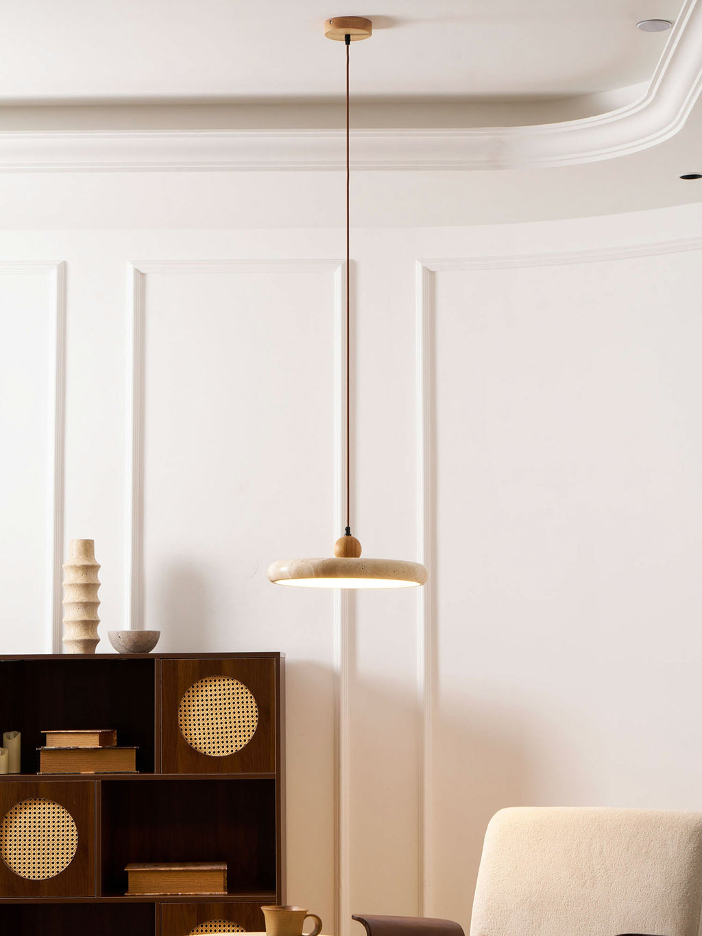 Travertine stone pendant light with warm wood frame glowing softly