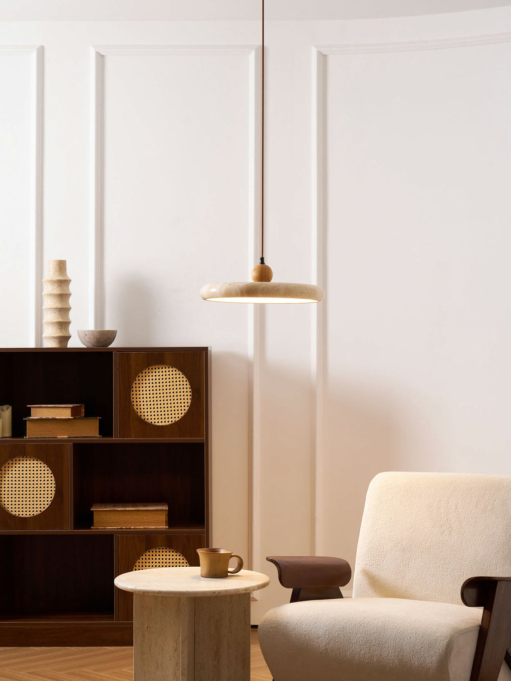 Yellow travertine disc pendant light suspended on a slim cable