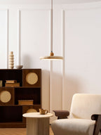 Yellow travertine disc pendant light suspended on a slim cable