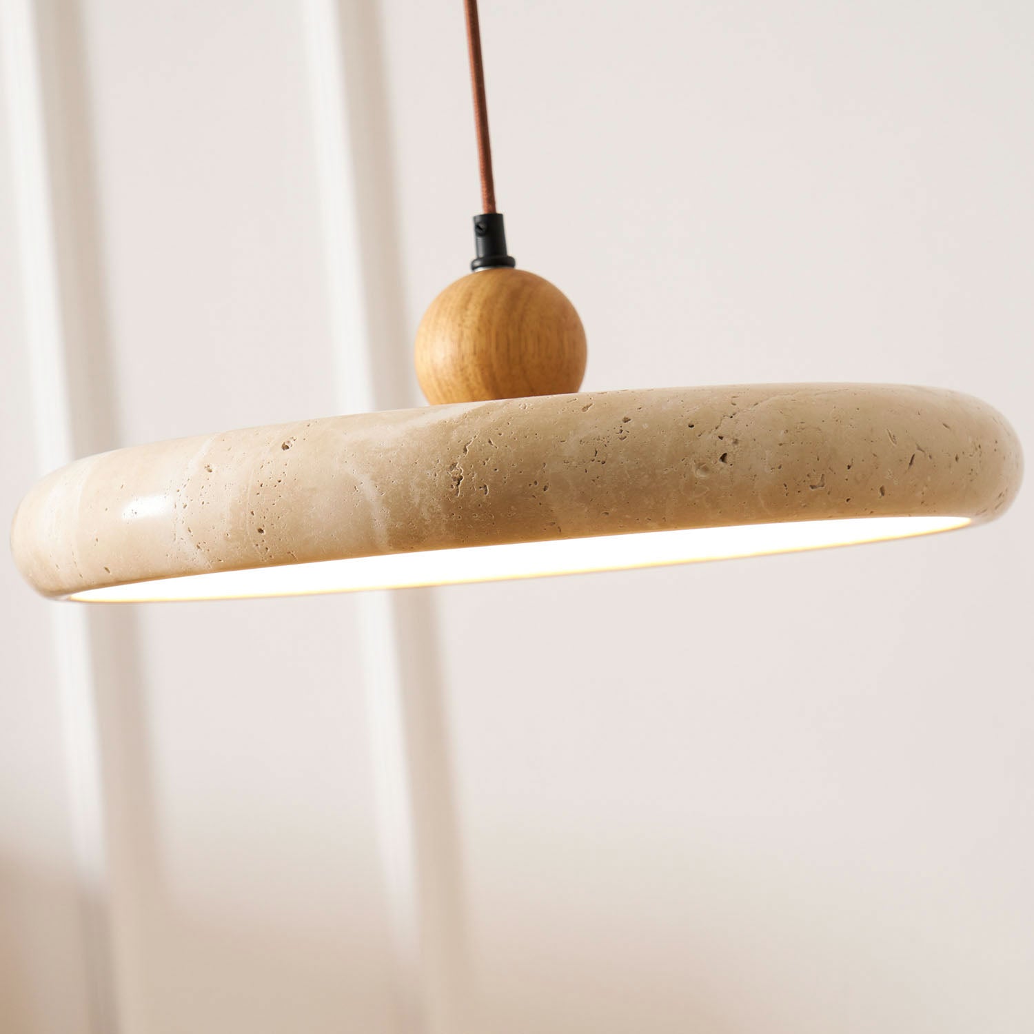 Travertine pendant light detail showing veined natural stone shade