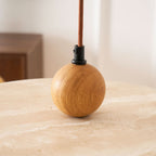 Yellow travertine pendant light glowing over a living room sofa