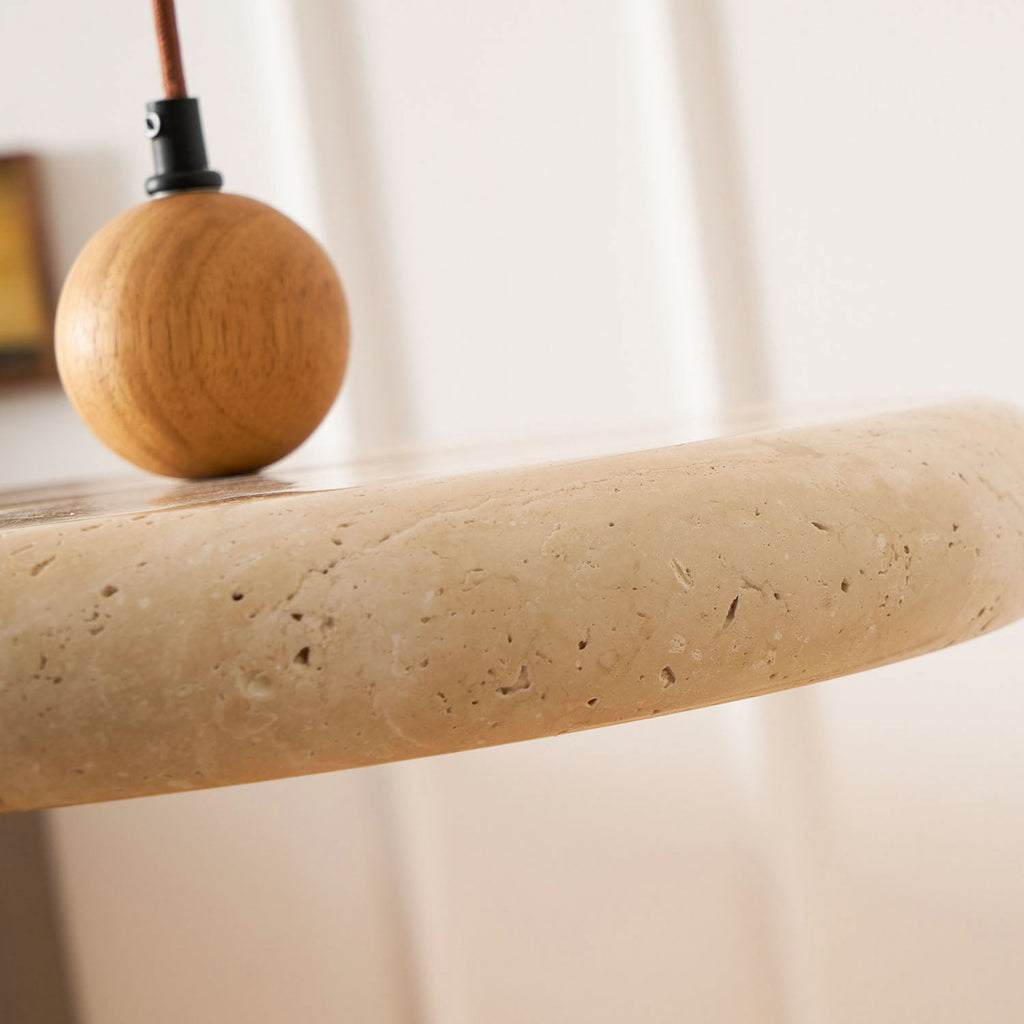 Travertine stone pendant light with wood frame in a bright space