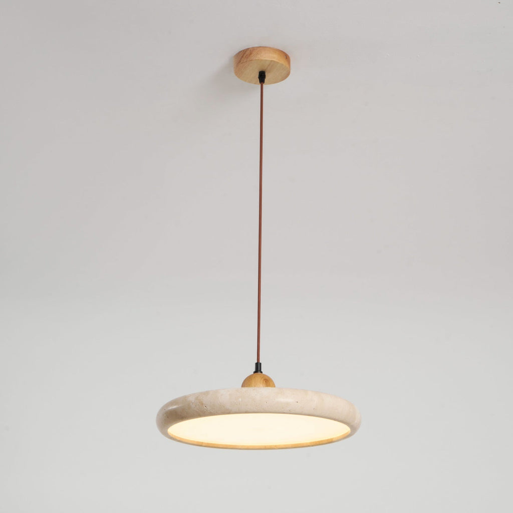 Travertine stone pendant light with wood frame glowing over a table