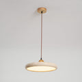 Travertine stone pendant light with wood frame glowing over a table