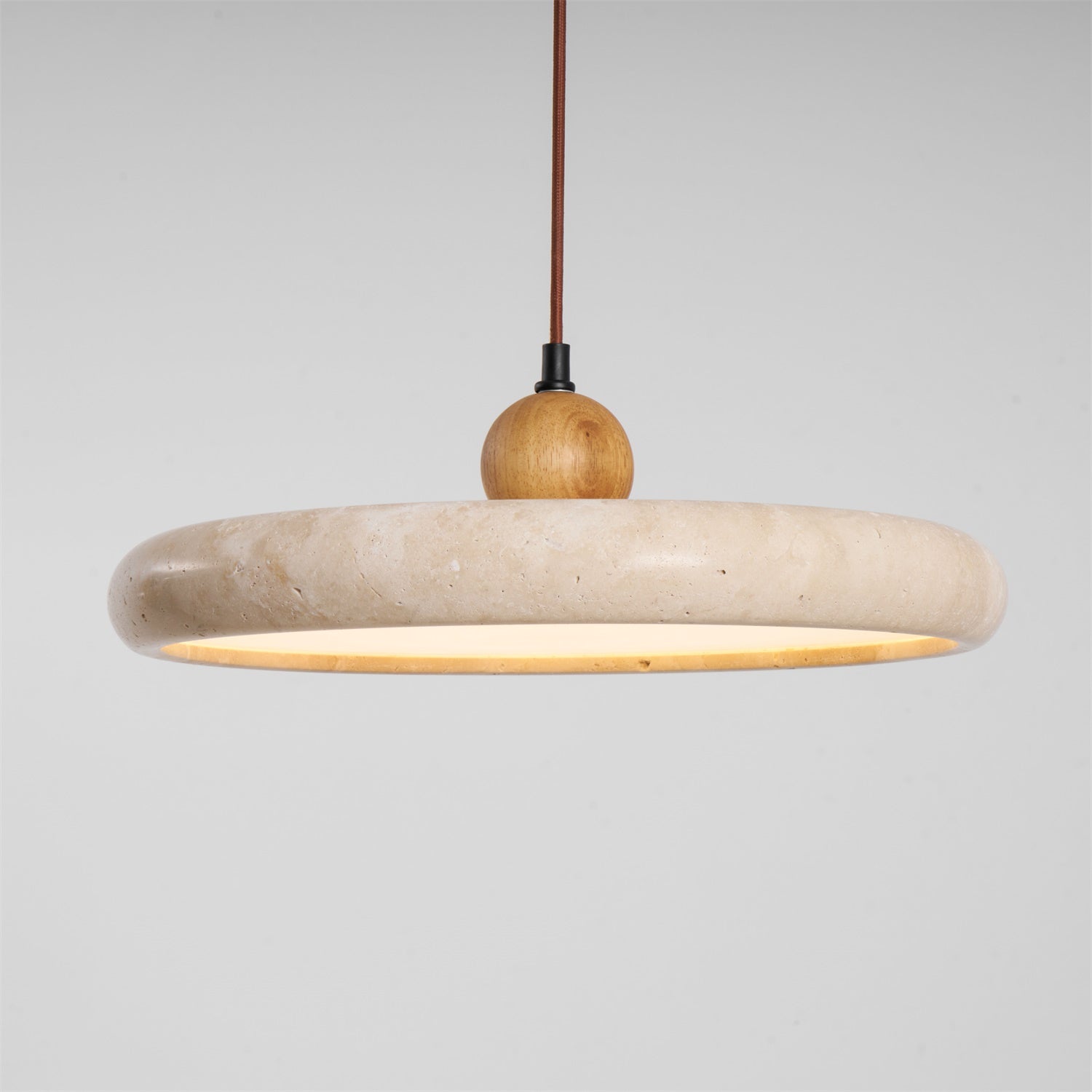 Yellow travertine disc pendant light with slim wooden frame detail