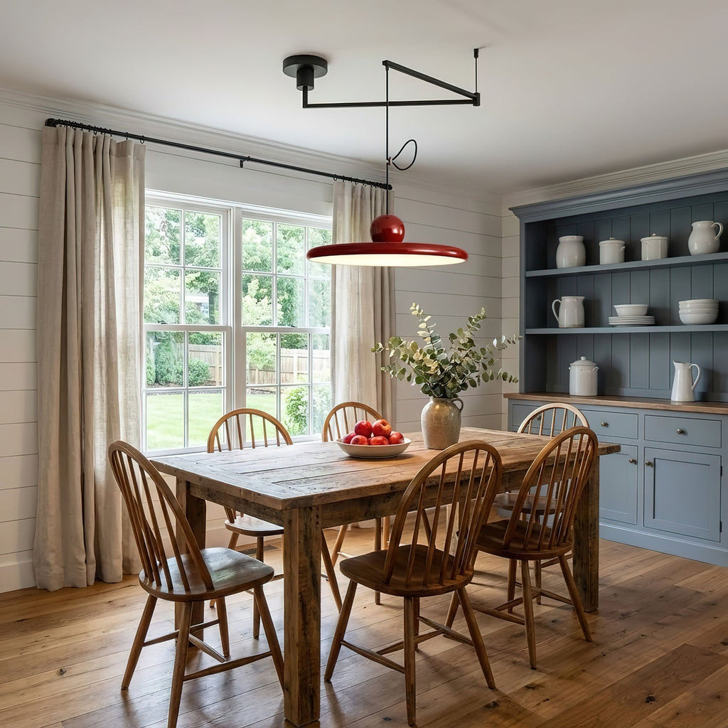 Disc pendant light on a swing arm hanging over a kitchen island