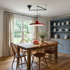 Disc pendant light on a swing arm hanging over a kitchen island
