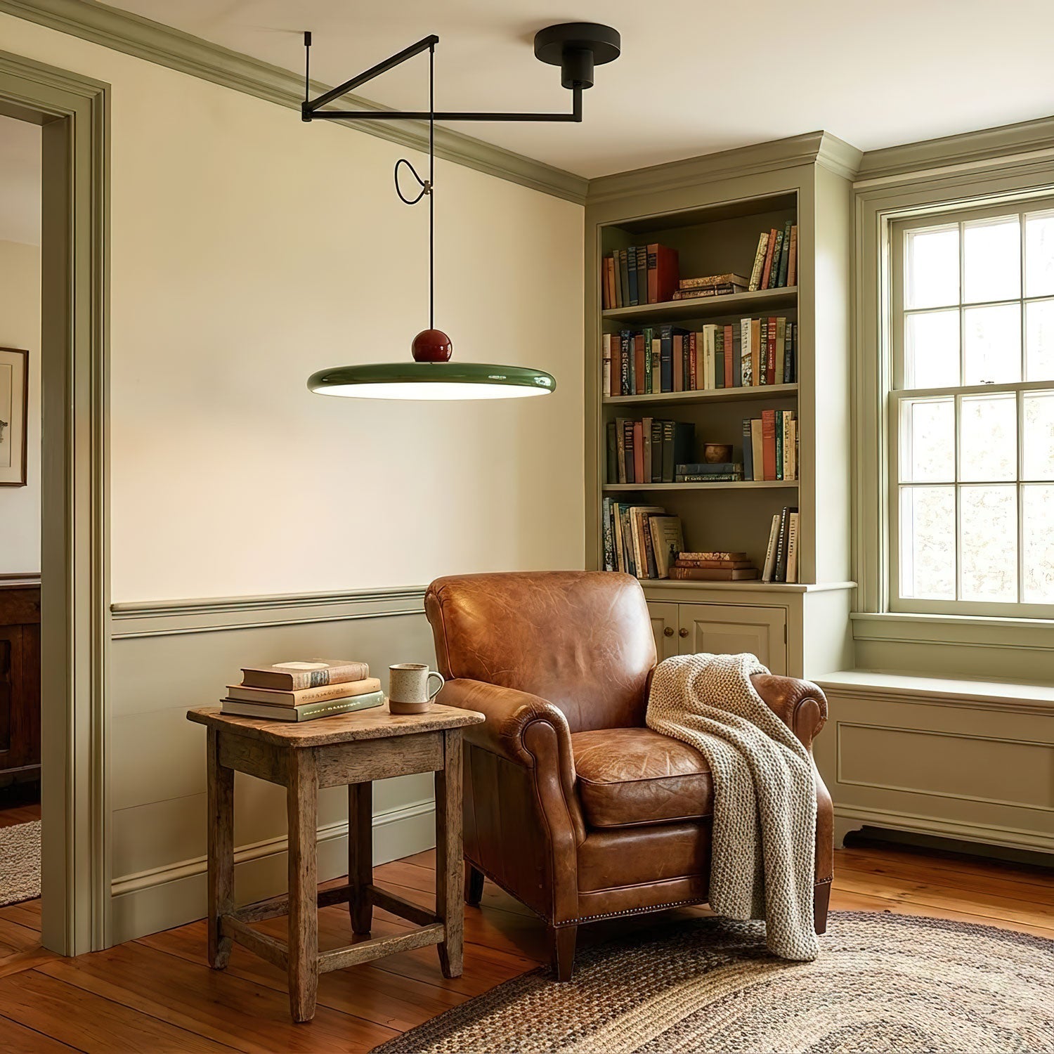 Mid-century swing arm pendant light shown over a dining setting