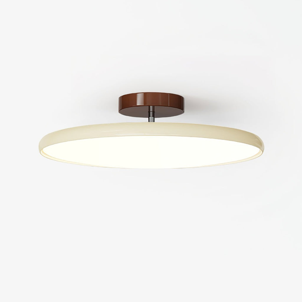Adjustable ceiling lamp aimed over a seating area, warm glow